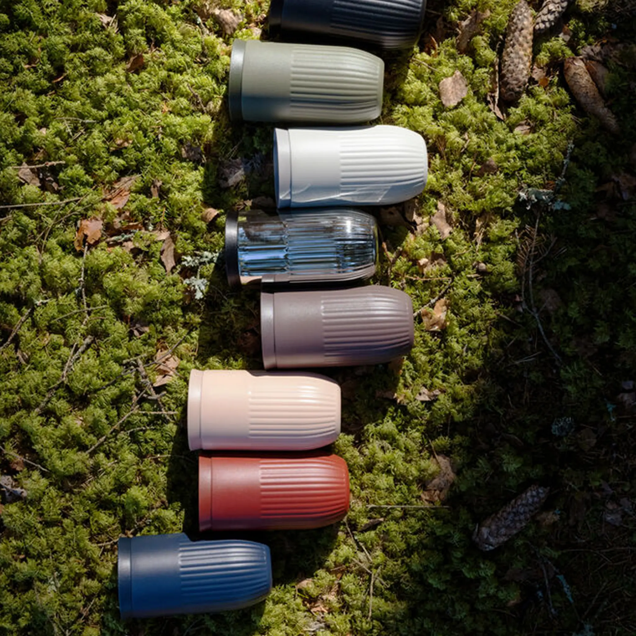 Sagaform Tova Mug Color Variations. The Mugs Are Laying In Gras